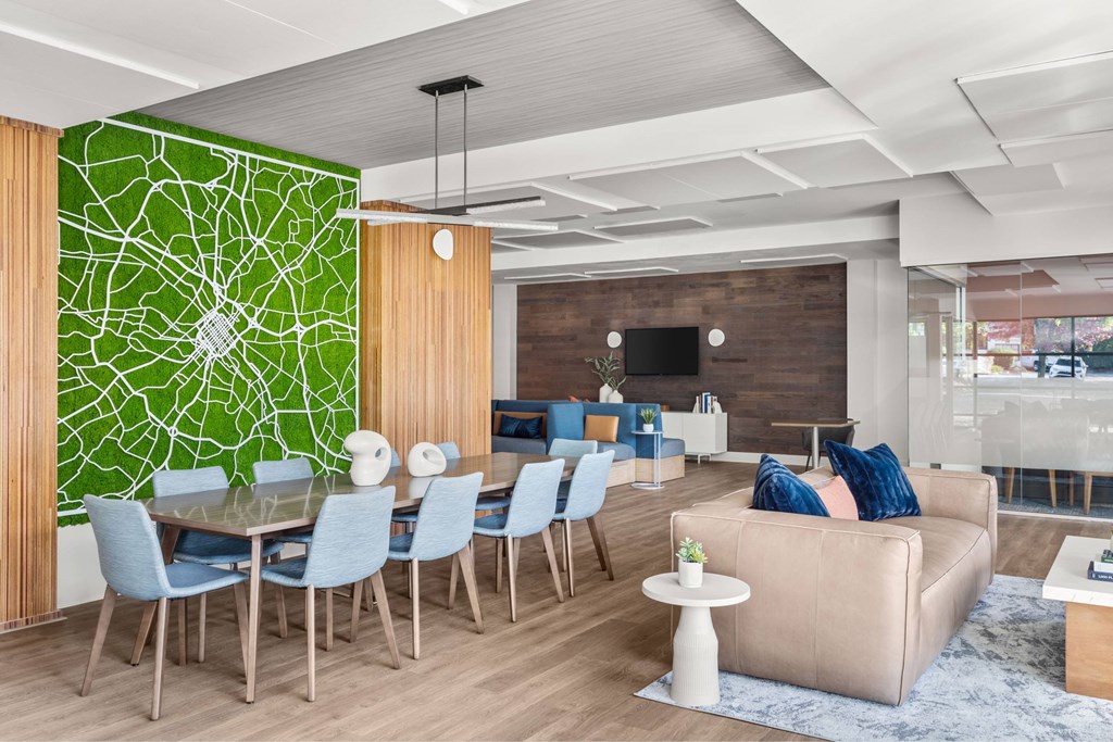 A modern living room with a green wall and a dining table.