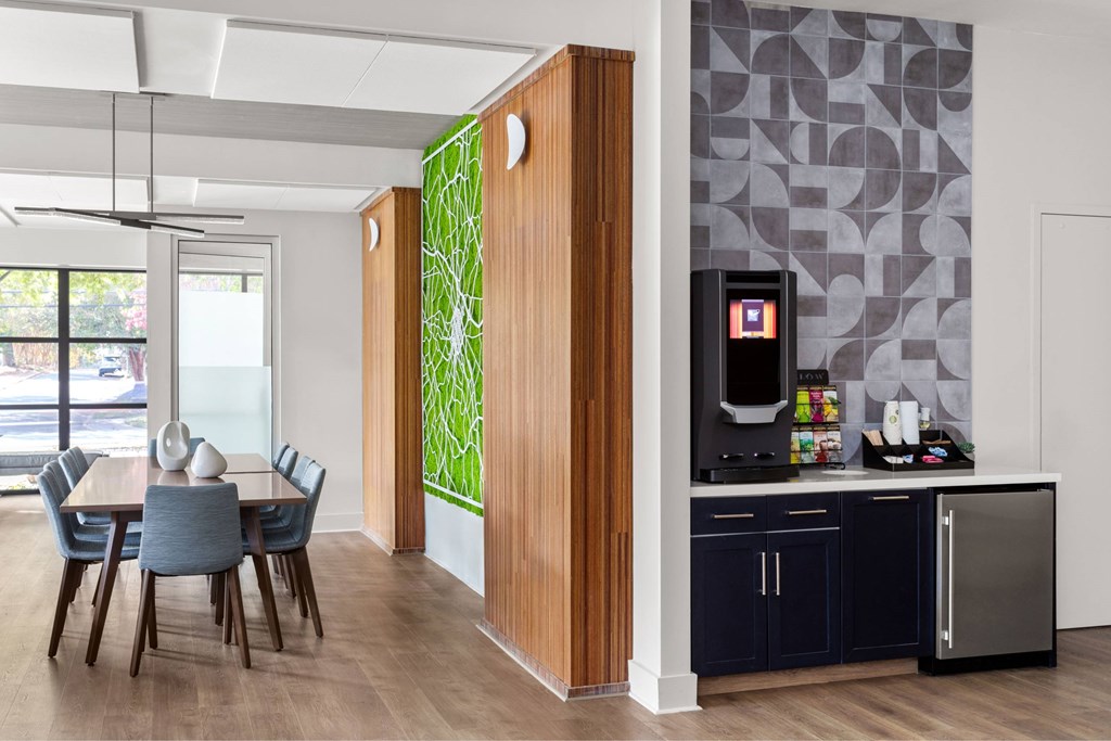 A kitchen with a dining table and chairs.