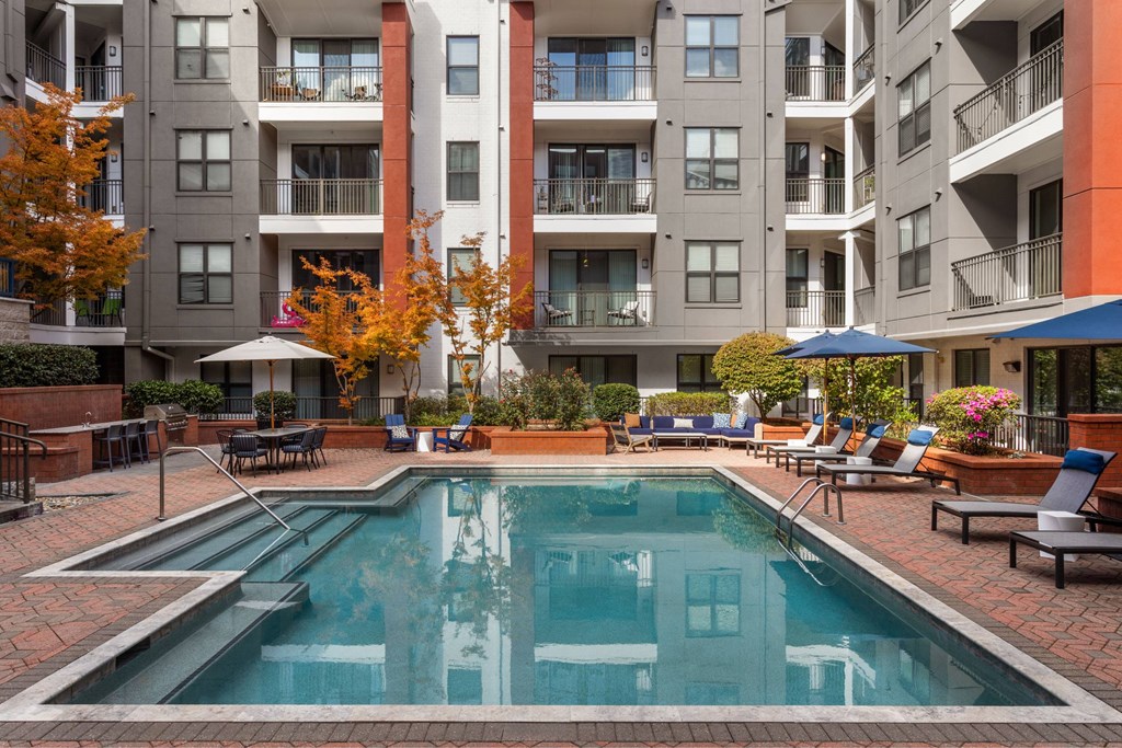 A swimming pool in front of apartment buildings.