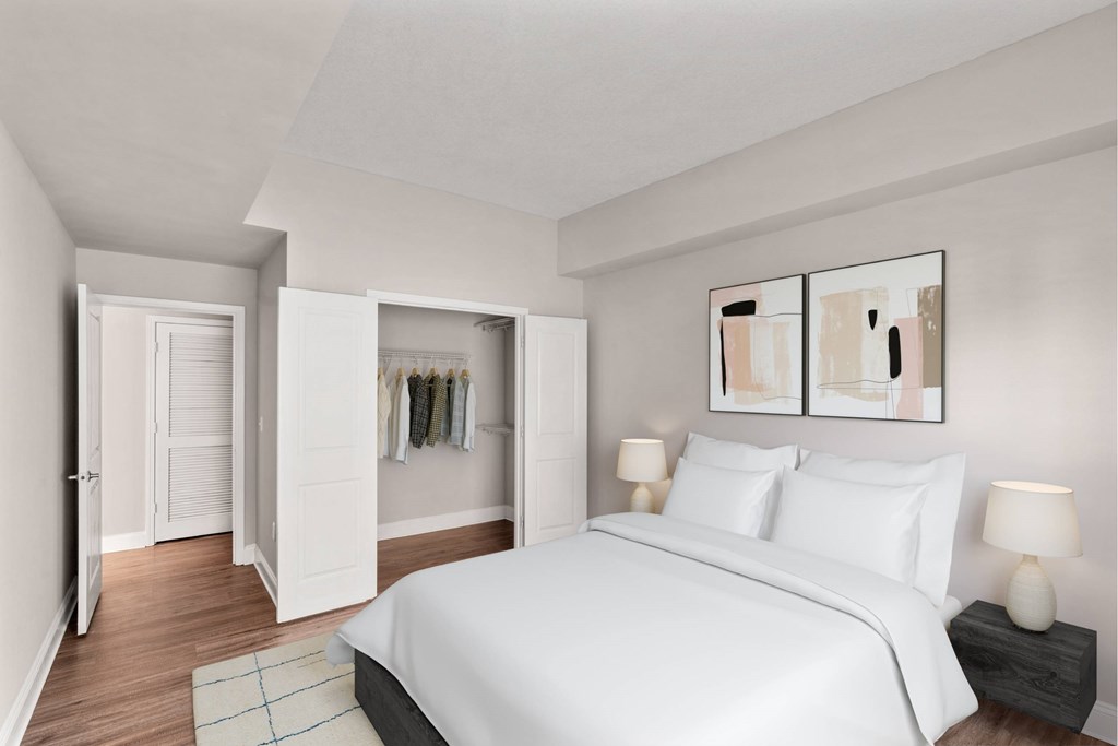 A bedroom with a large bed and a painting on the wall.