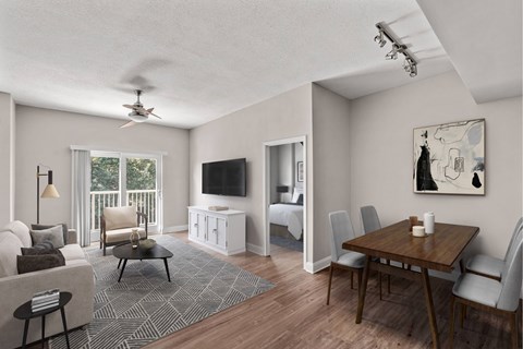 A living room with a television, a couch, a chair, a table, and a painting on the wall.