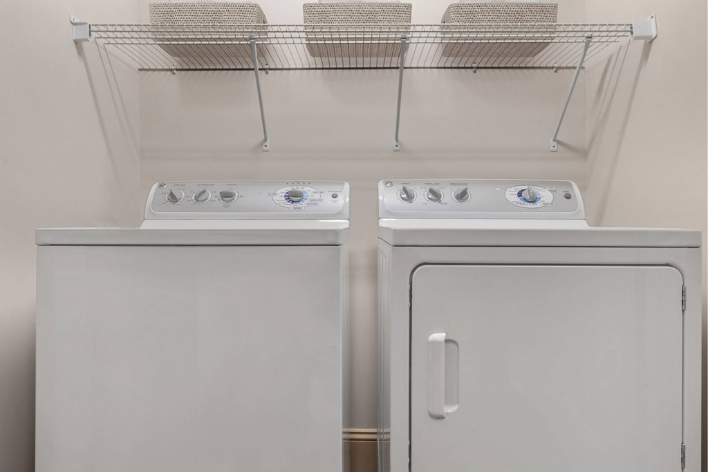 Two white ovens are in a kitchen.