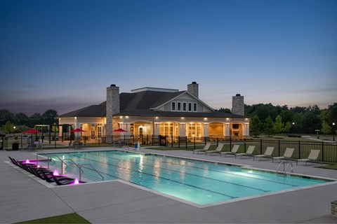 A large house with a pool in front of it.