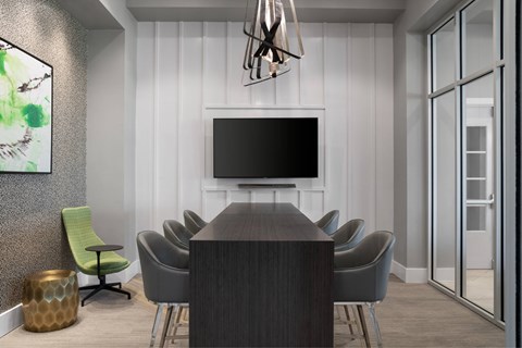 A conference room with a long table and chairs.