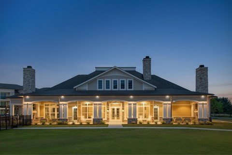 A large house with a front porch and two chimneys.