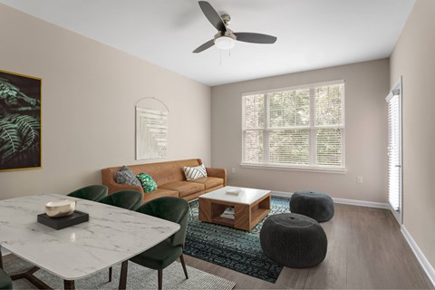 A living room with a couch, chairs, and a coffee table.