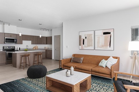 A modern living room with a brown couch and a coffee table.