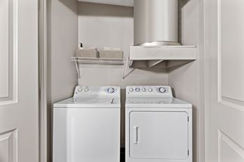 A white washing machine and dryer in a small laundry room.