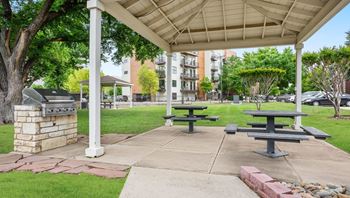A covered picnic area with tables and benches.