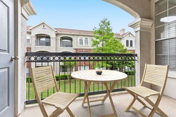 A patio with a table and two chairs is shown.