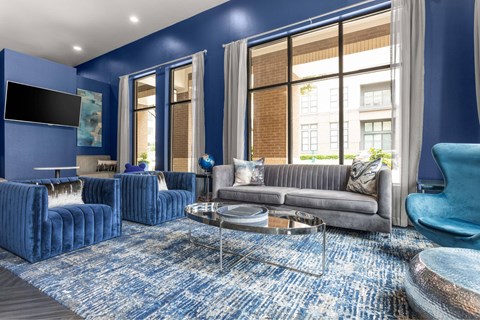 A living room with blue walls and furniture.