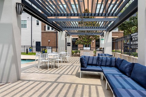 A patio with a blue couch and a pool table.
