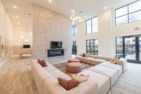 A living room with a white sofa and a fireplace.