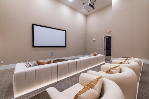 A home theater with a large screen and comfortable seating.