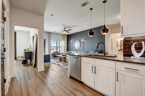 A modern kitchen with white cabinets and a large island.