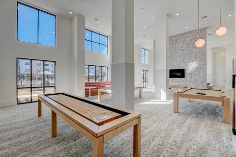 A room with a long table and a bench.