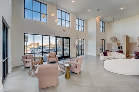 A spacious living room with a large window and a view of the street.