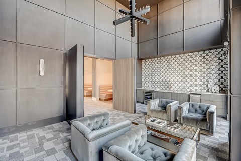 A modern living room with grey and white decor.