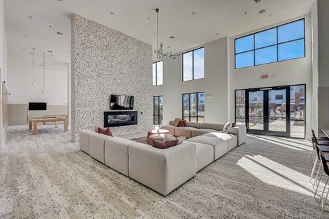 A modern living room with a large sectional sofa and a flat screen TV.