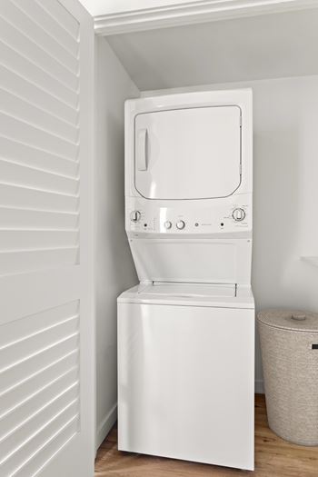 A white washing machine in a small room.