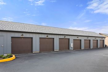 A long building with garage doors on the side.