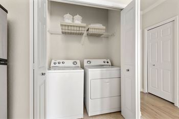A white laundry room with a washer and dryer.