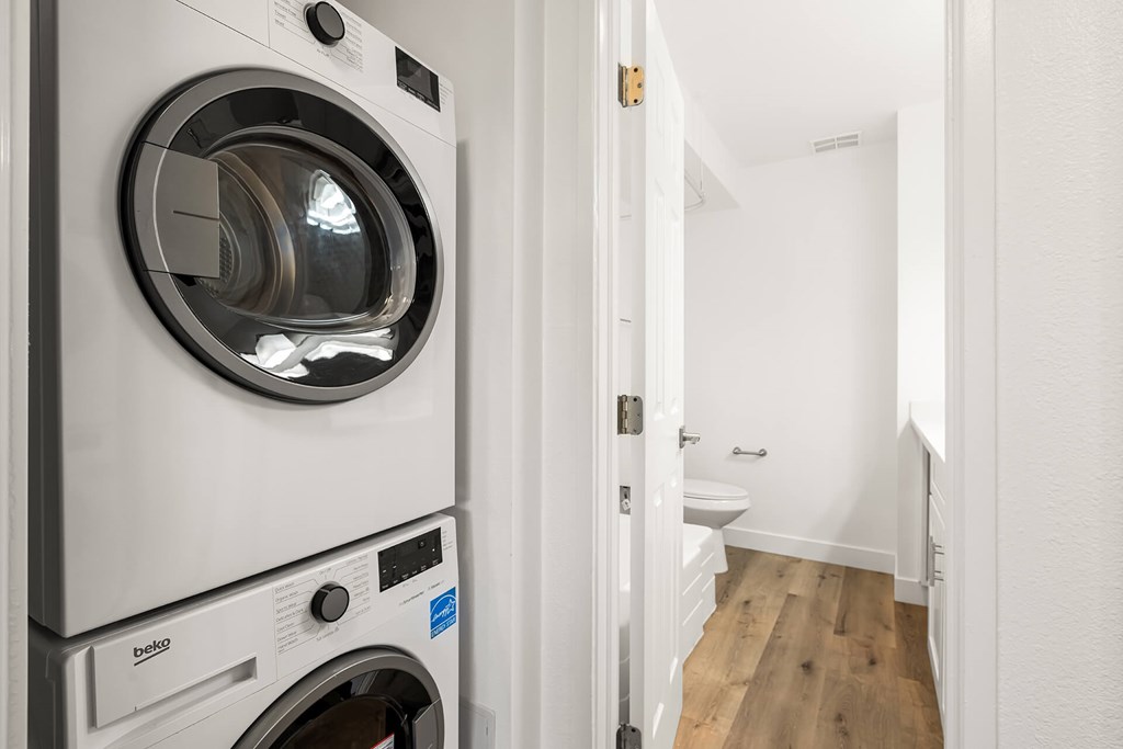 A white washing machine and dryer in a small room.