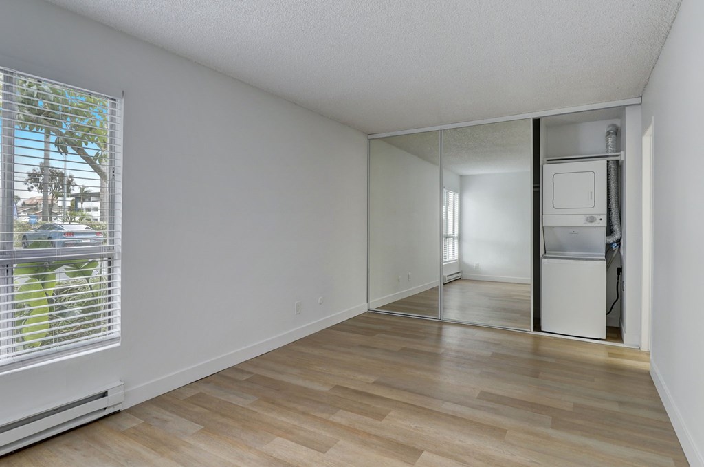 A room with a window and a sliding glass door.