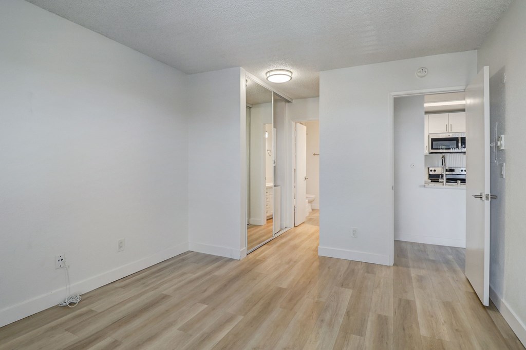 A room with wooden floors and white walls.