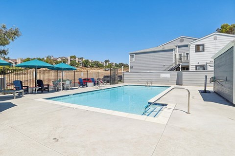 A swimming pool with a slide and a fence.