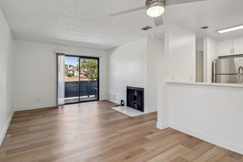 A spacious living room with a fireplace and sliding glass doors.