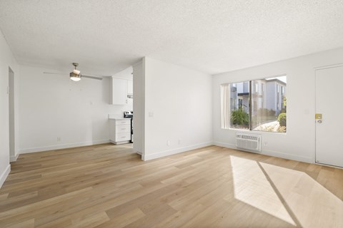 A room with wooden floors and white walls.