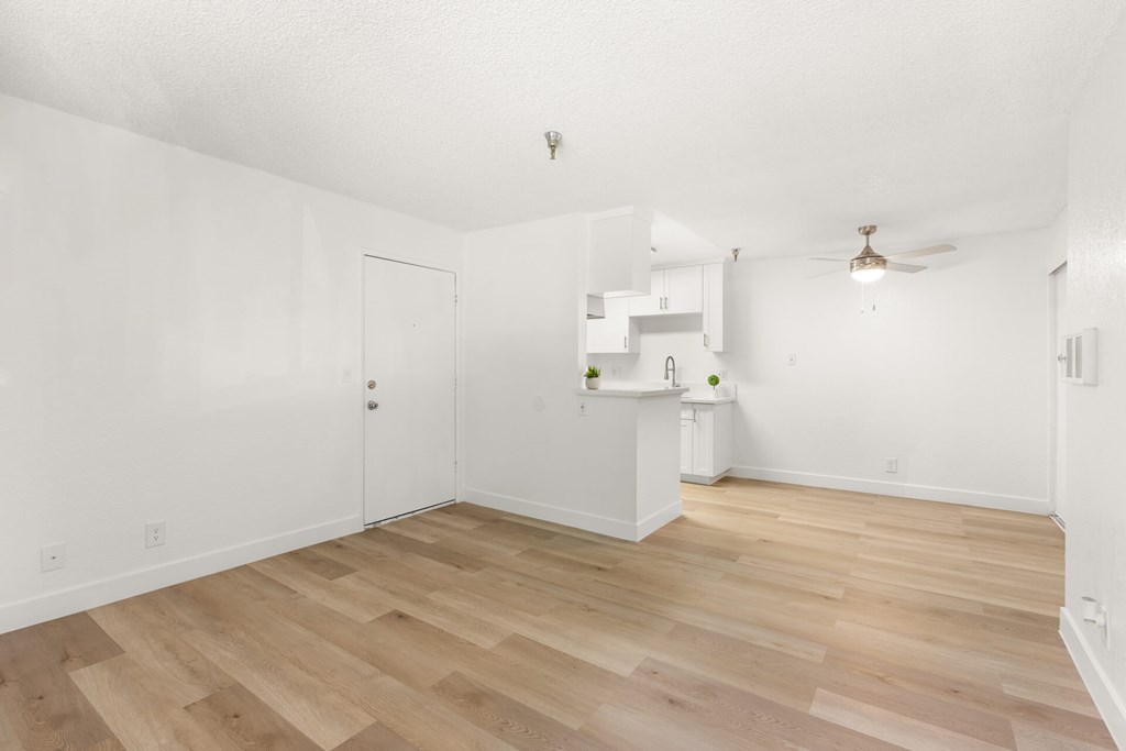 A room with wooden floors and white walls.