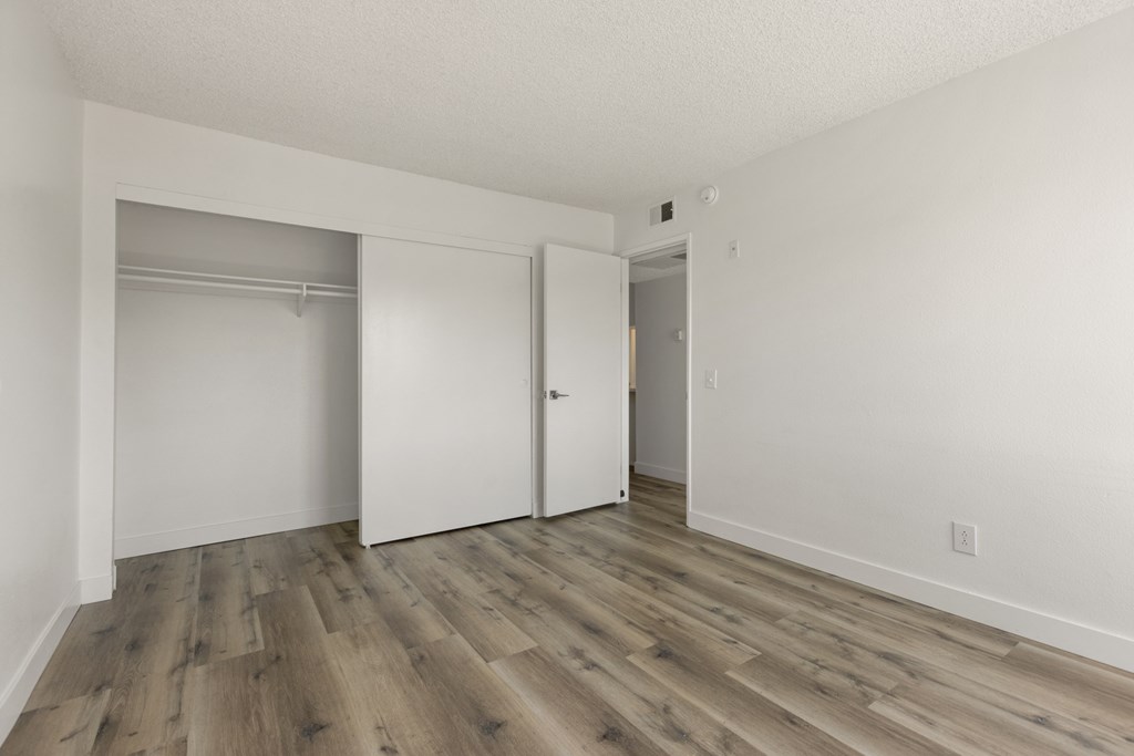 A room with a white door and a white wall.