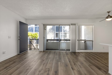 A room with wooden floors and a ceiling fan.