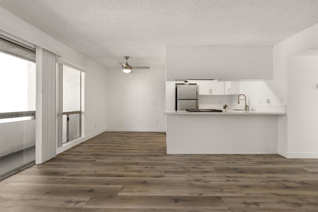 A kitchen area with a countertop and cabinets.