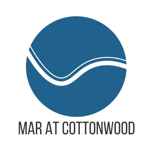 A blue circle with a white line and the words "Mar at Cottonwood" written below it.