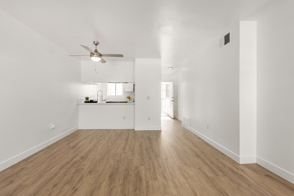 A room with a ceiling fan and light fixture.