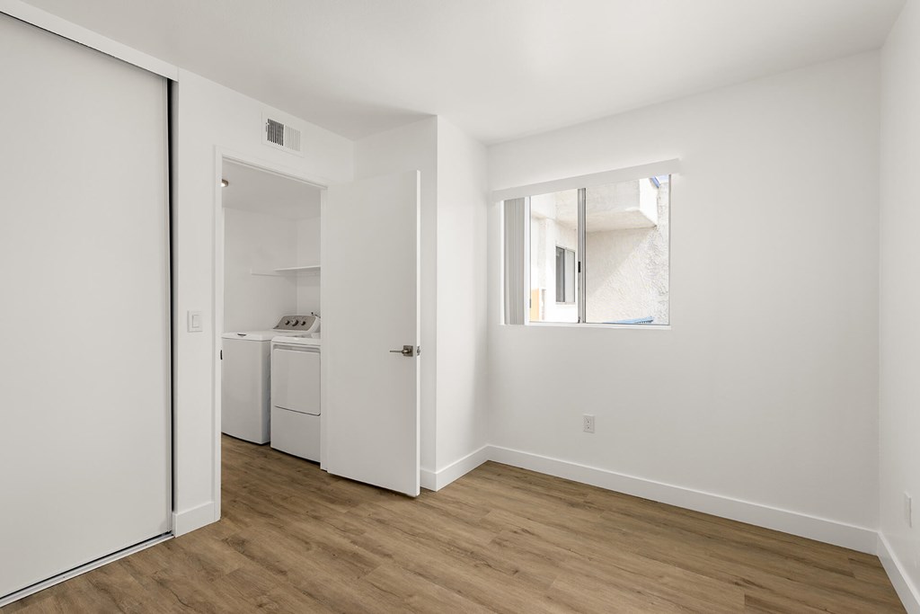 A white laundry room with a washer and dryer.