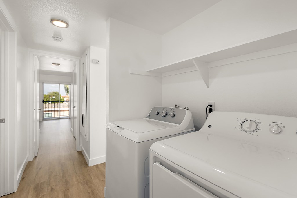 A white laundry room with a washer and dryer.