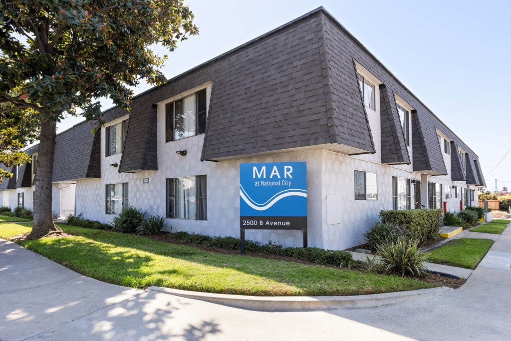 A white building with a blue sign that says MAR on it.
