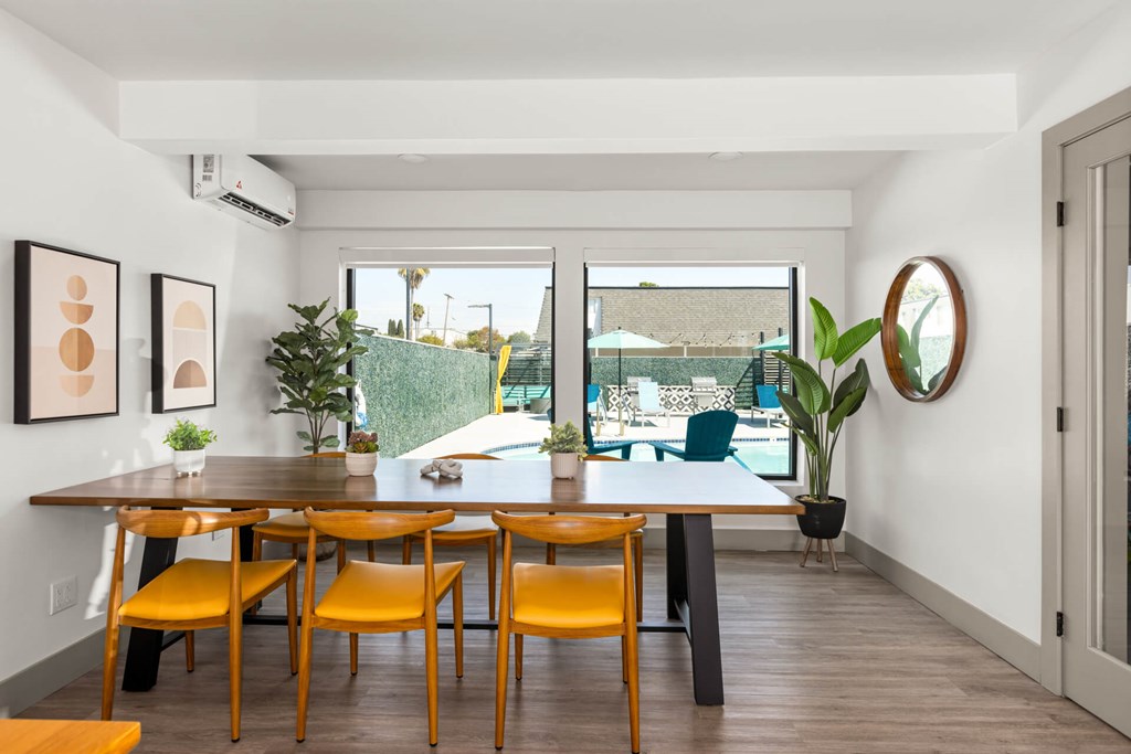 A dining room with a table and chairs.