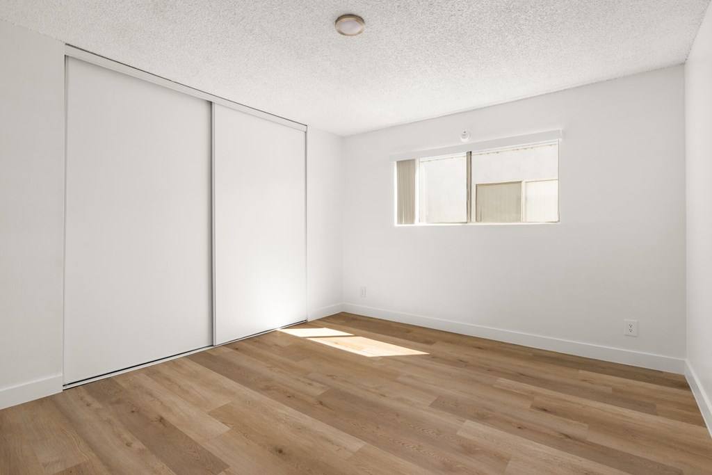 A room with a sliding door and a window.