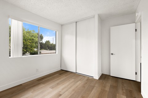 A room with a sliding door and a window.