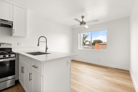 A kitchen with white cabinets and a stainless steel oven.