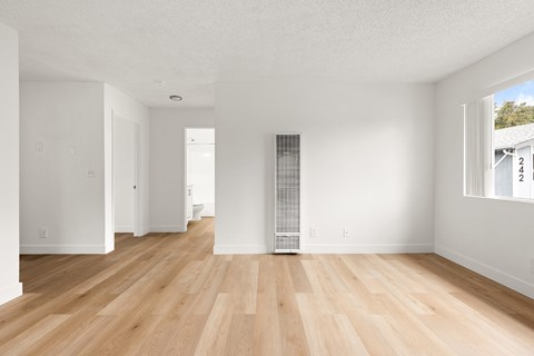 A room with wooden floors and white walls.