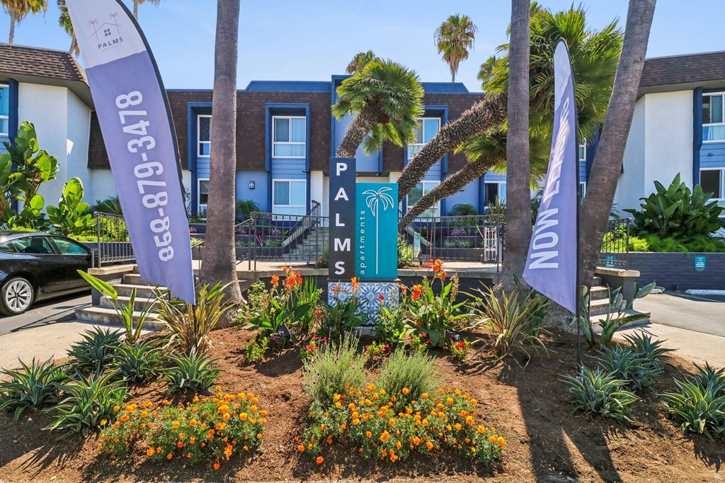 A garden with a sign that says Palms.