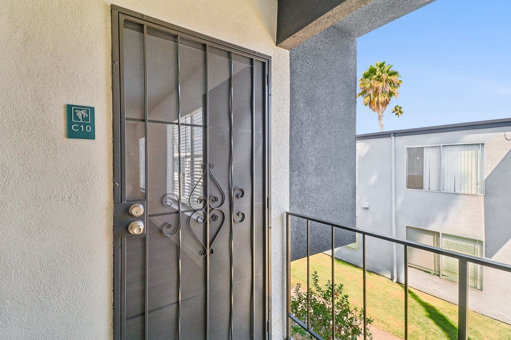 A glass door with a metal handle and a sign on the wall.