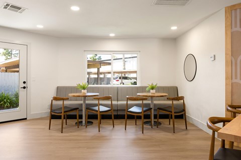 A modern dining area with a long table and chairs.