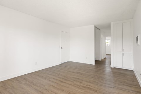 A room with wooden floors and white walls.